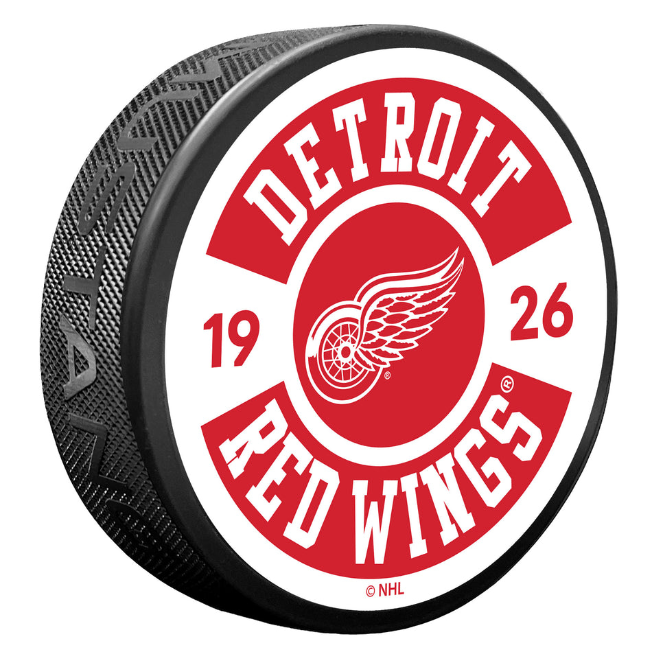 Detroit Red Wings puk Cog - Detroit Red Wings hokejové vybavení